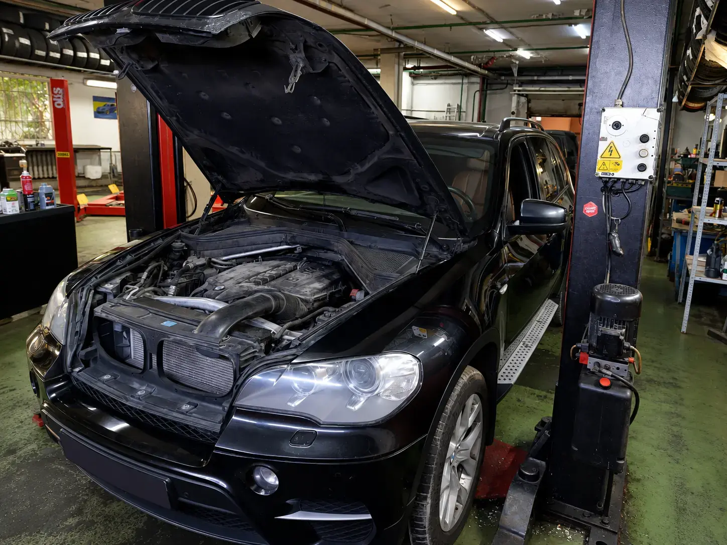 BMW с открытым капотом на сервисном посту